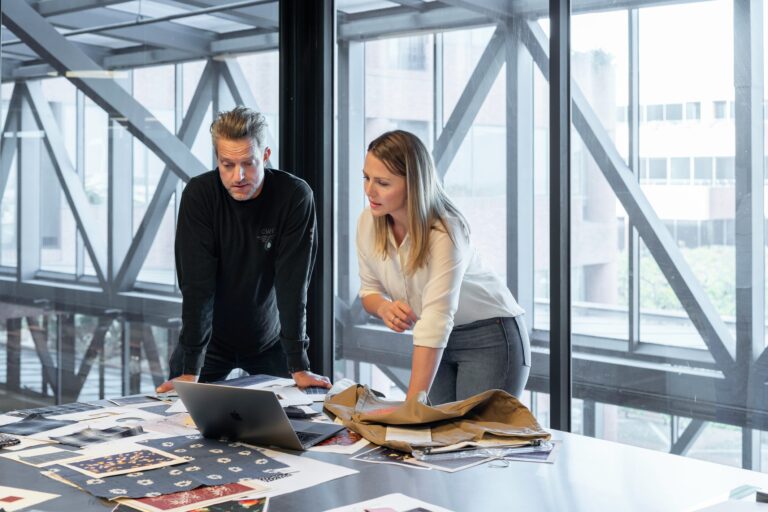 a male and a female in office wear looking at a visa extension paper